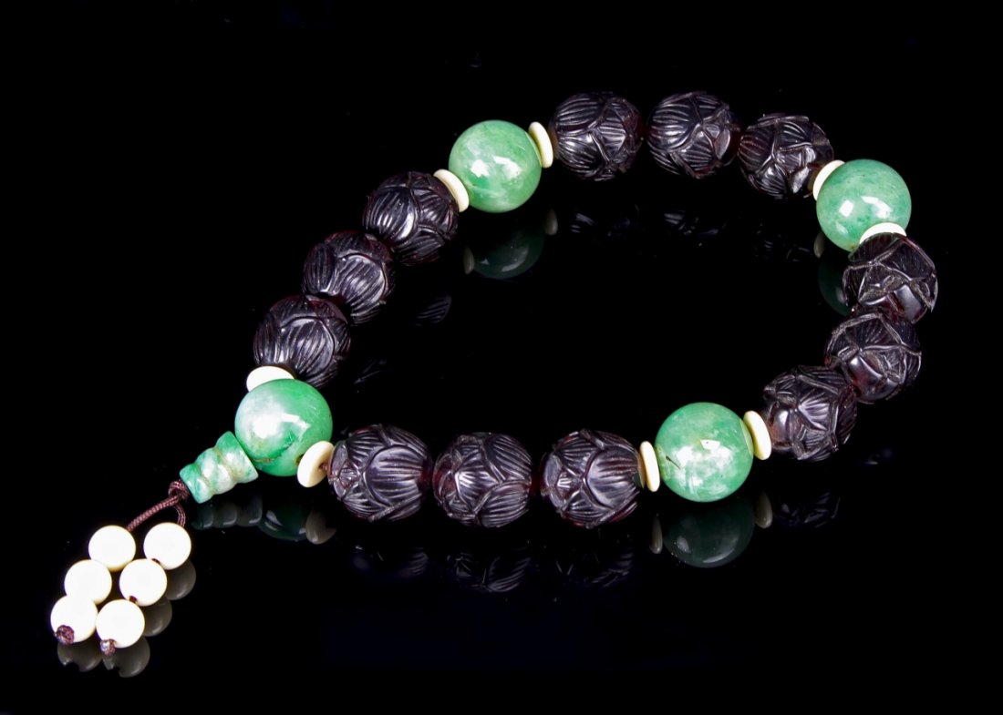 Chinese Amber-Jadeite Buddhist Prayer Beads: China, amber-jadeite Buddhist prayer beads, twelve amber beads carved as lotus blossom spaced with four larger jadeite beads. Diameter 0.70 mm.