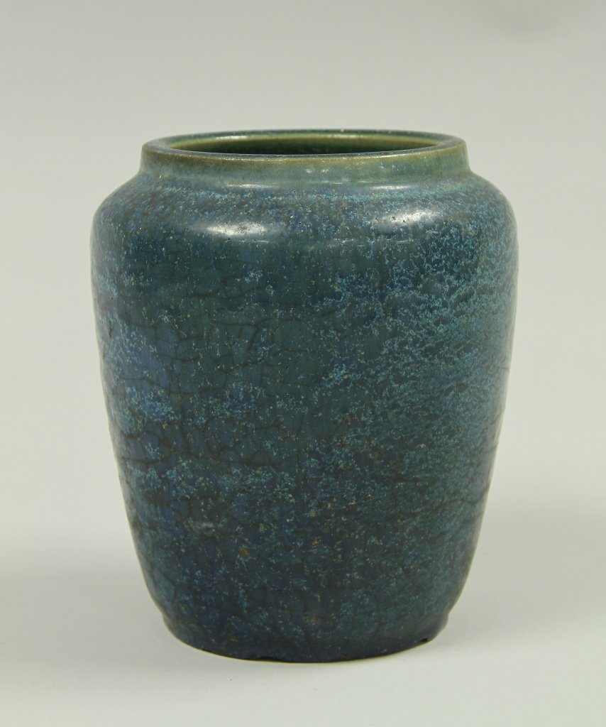 Blue Glazed Pottery Pot: 1920's, blue glazed pottery pot, with rounded shoulders and an opening for the mouth, covered in an all over blue glaze, slight speckling seen throughout the glaze. Height 6 in., Width 5 in.