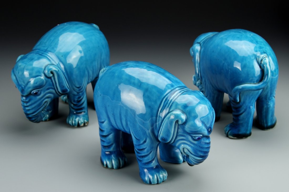 Three Chinese Glazed Elephants: China, three export turquoise glazed elephants with curled trunks and heads bent towards the ground, prominent wrinkles across skin and stylized facial features. Height 4 1/2 in. Provenance: From the 