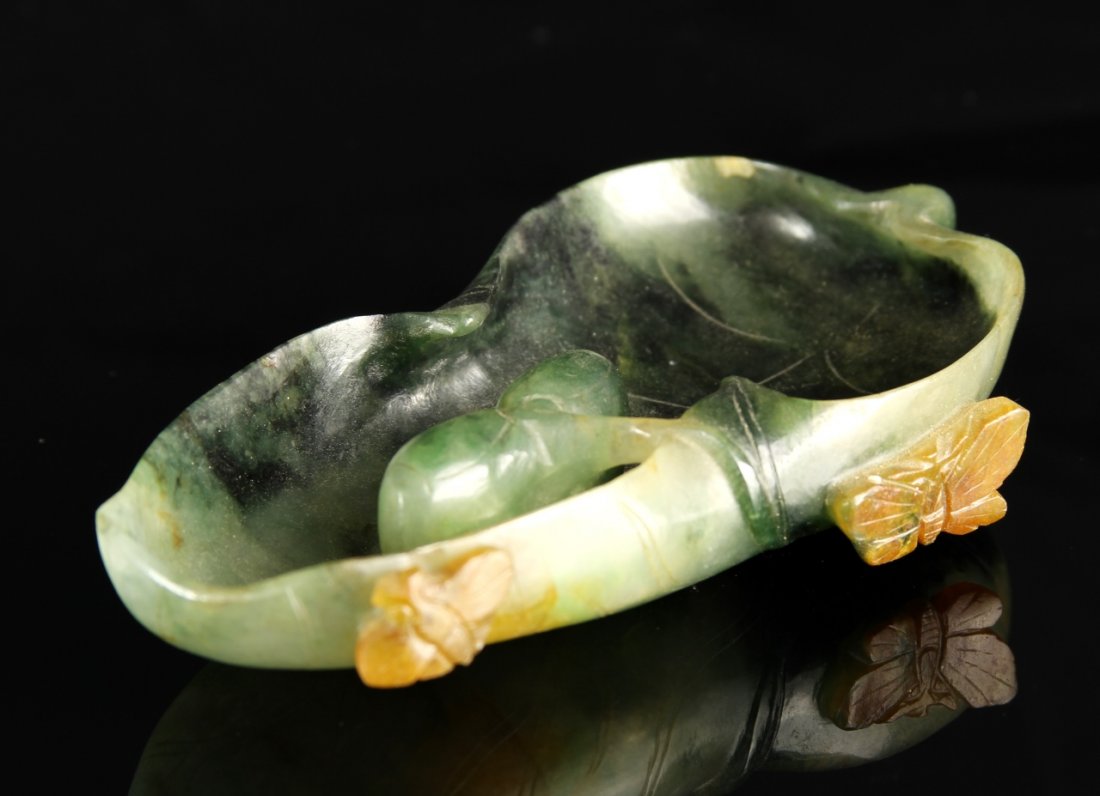 Chinese Carved Jade Brush Washer: China, 19th C., carved jade brush washer, in a naturalistic form, with a carved butterfly adorning the side, and striations in the stone. Width 4 1/4 in., Height 2 1/4 in. Provenance: From the private