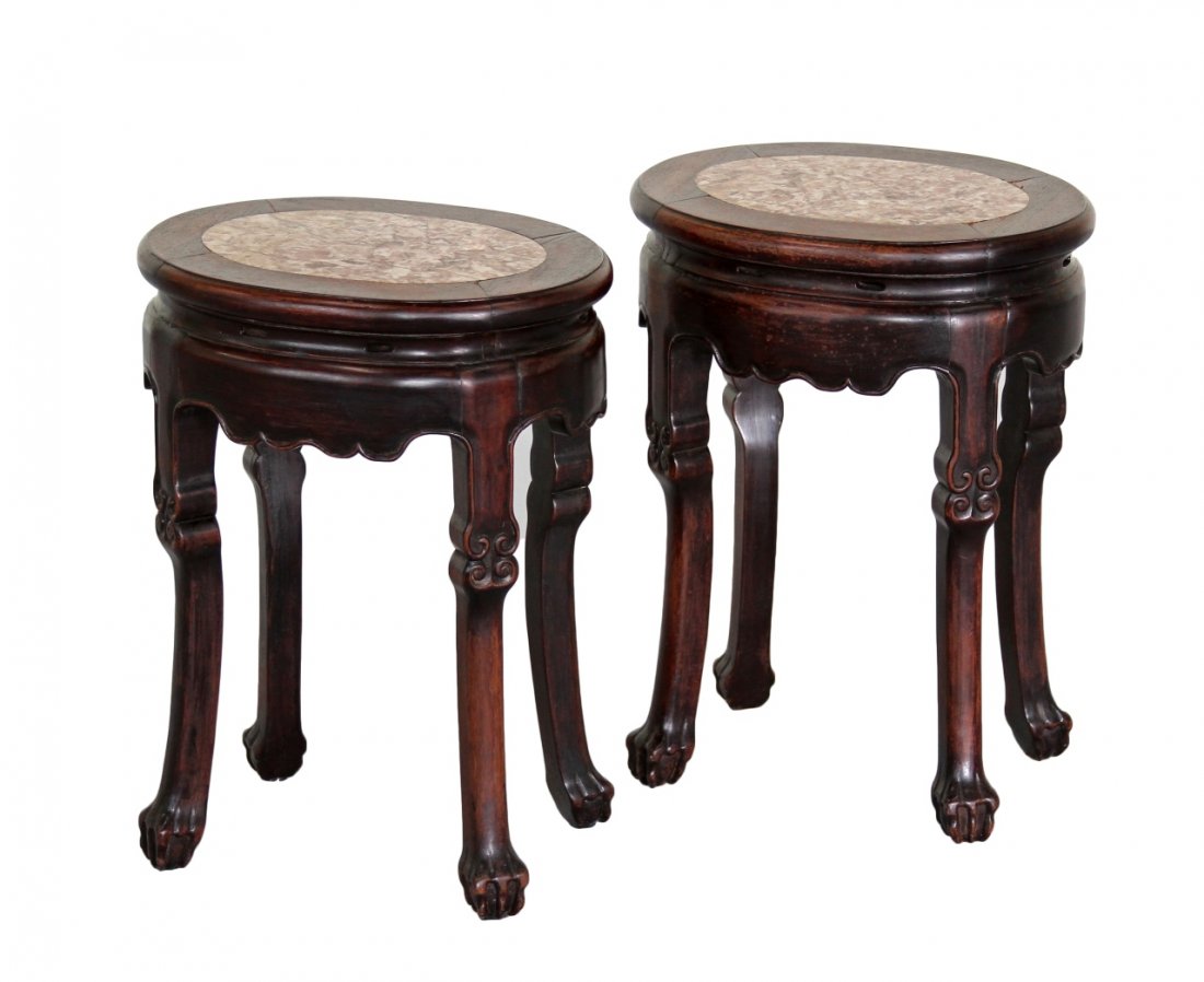 Pair of Chinese Rosewood Stools: China, a pair of rosewood stools, in a circular form, with a stone inlayed top, spiral ornamentation at the center of the legs, with pronounced three clawed feet. Height 19 1/2 in.
