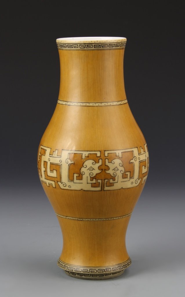Chinese Porcelain Bamboo Vase: China, 19th C., porcelain vase, imitating the pattern and color of bamboo, with a Chi dragon painting, and key-fret at the base and top, Qianlong mark on base. Height 10 in.