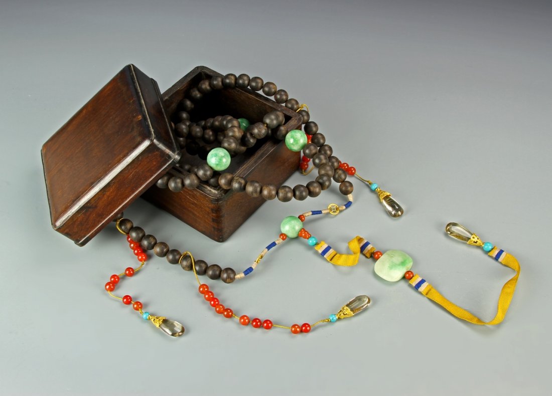 Indonesian Chenxiang Court Necklace: Indonesia, Chenxiang court necklace, string of 108 spherical dark Chenxiang beads, with four larger jadeite beads and a jadeite beiyun plaque, together with three strands of agate beads each suspendin