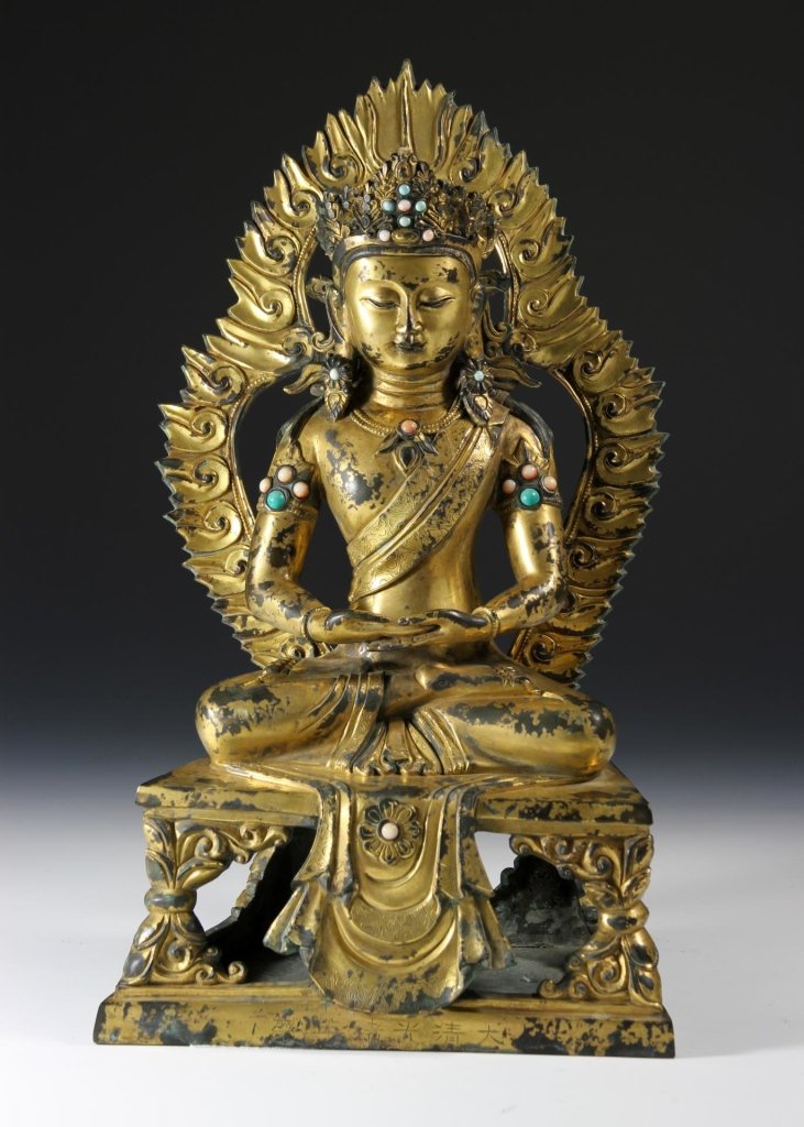 Chinese Gilt Bronze Buddha: China, late 19th C., gilt bronze figure of Buddha, in a seated position, surrounded by flames and wearing flowing robes and an elaborate headdress with inlaid stones of turquoise and coral, on a bench