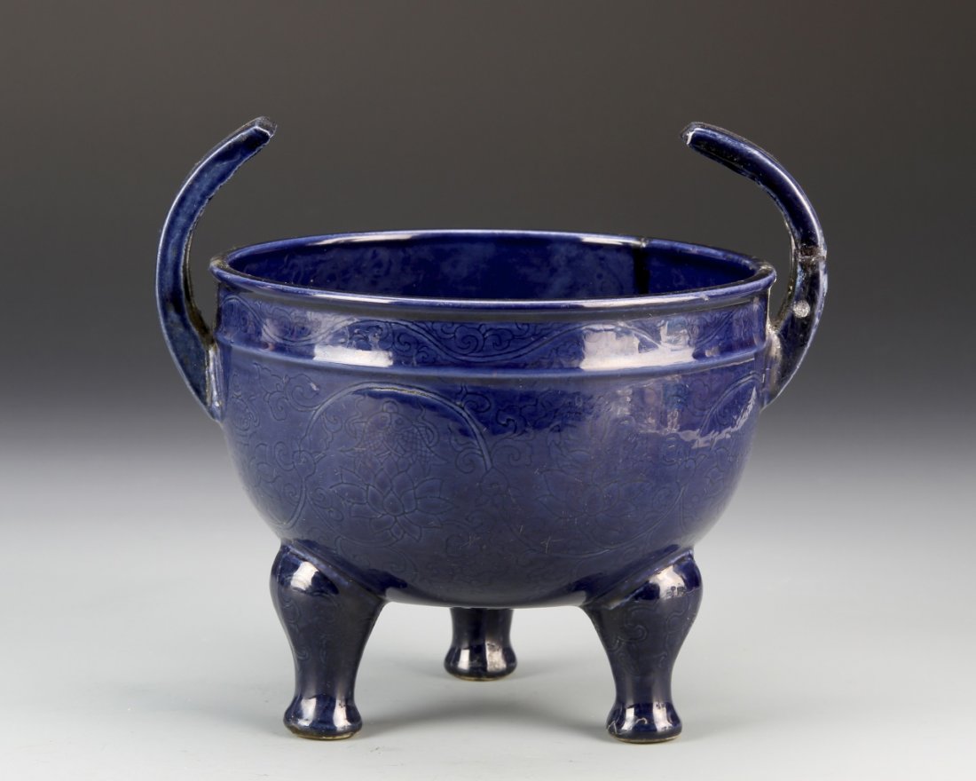 Chinese Antique Blue Tripod Censer: China, antique blue tripod censer , on tripod feet, a bulbous body and abstract, curved handles, the body decorated with delicate scrolling lotus motif with jumping fish throughout, Ming mark on base,