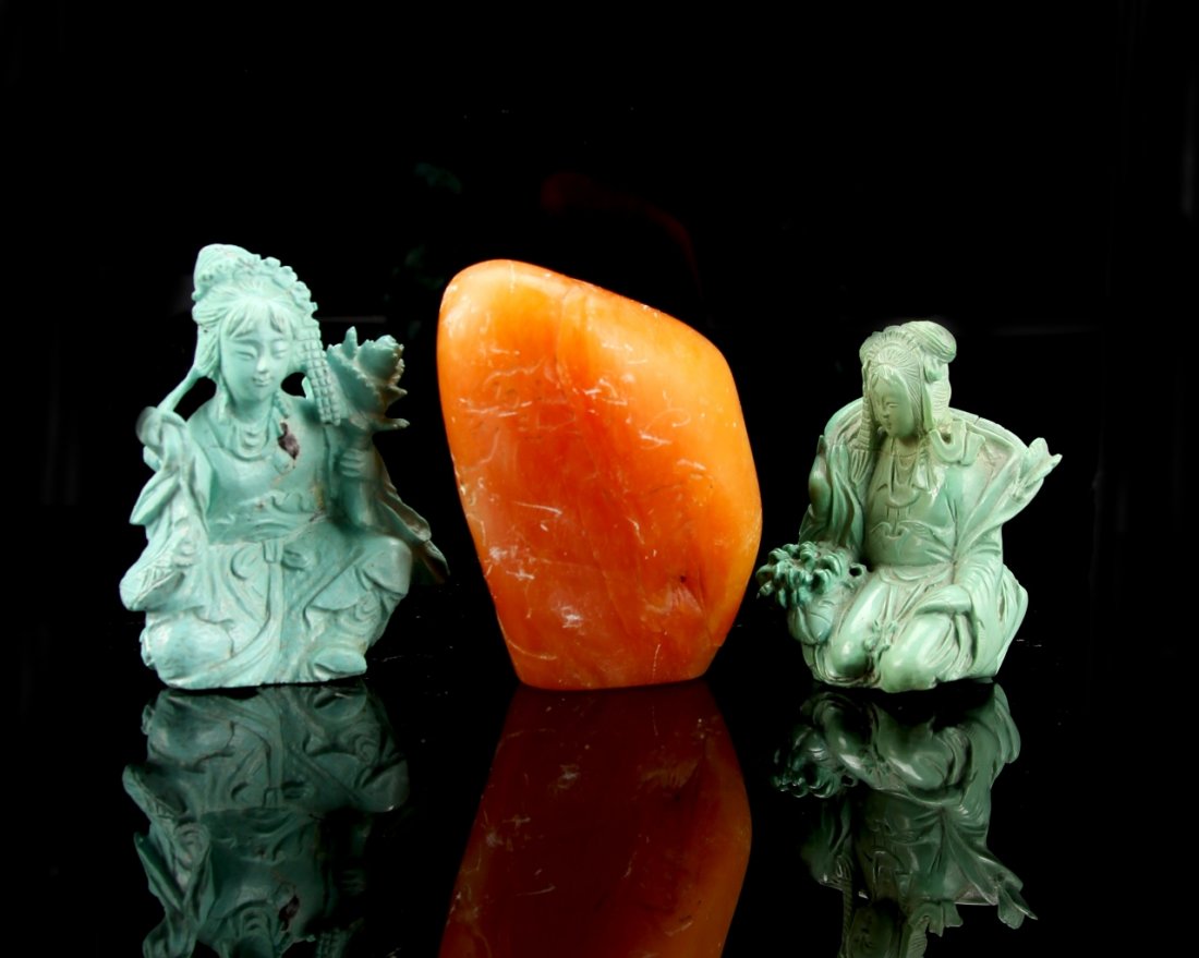 Two Chinese Figures and a Seal: China, two turquoise figures and a soap stone seal, both figures in a seated position, intricately carved, with flowing robes and objects in hand, stone in orange hue. Height 2 1/2 in.