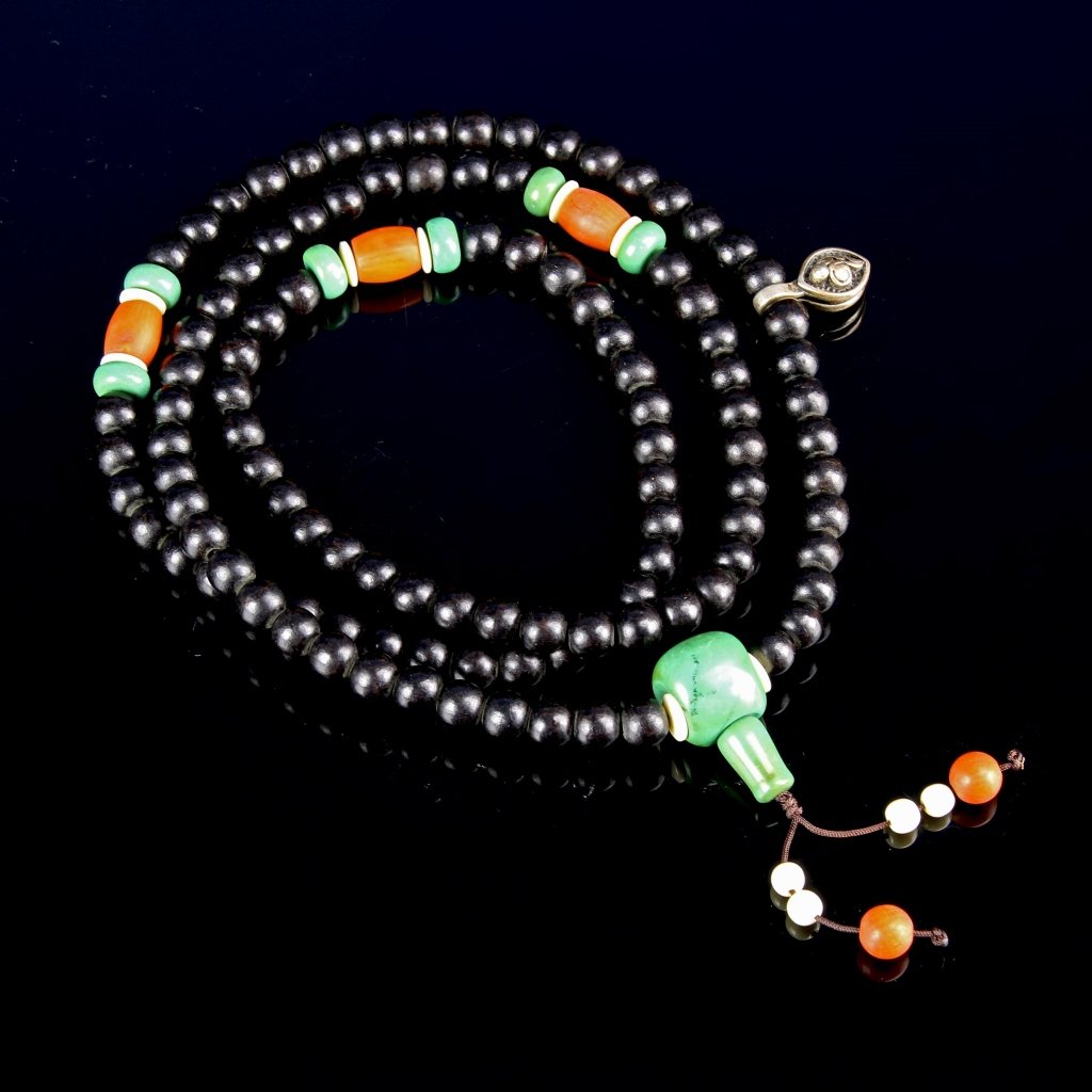 Indonesian Black Chenxiang Prayer Beads: Indonesia, black Chenxiang prayer beads, comprising 108 spherical black Indonesian Chenxiang beads, spaced with coral, and turquoise beads. Length 33 in.