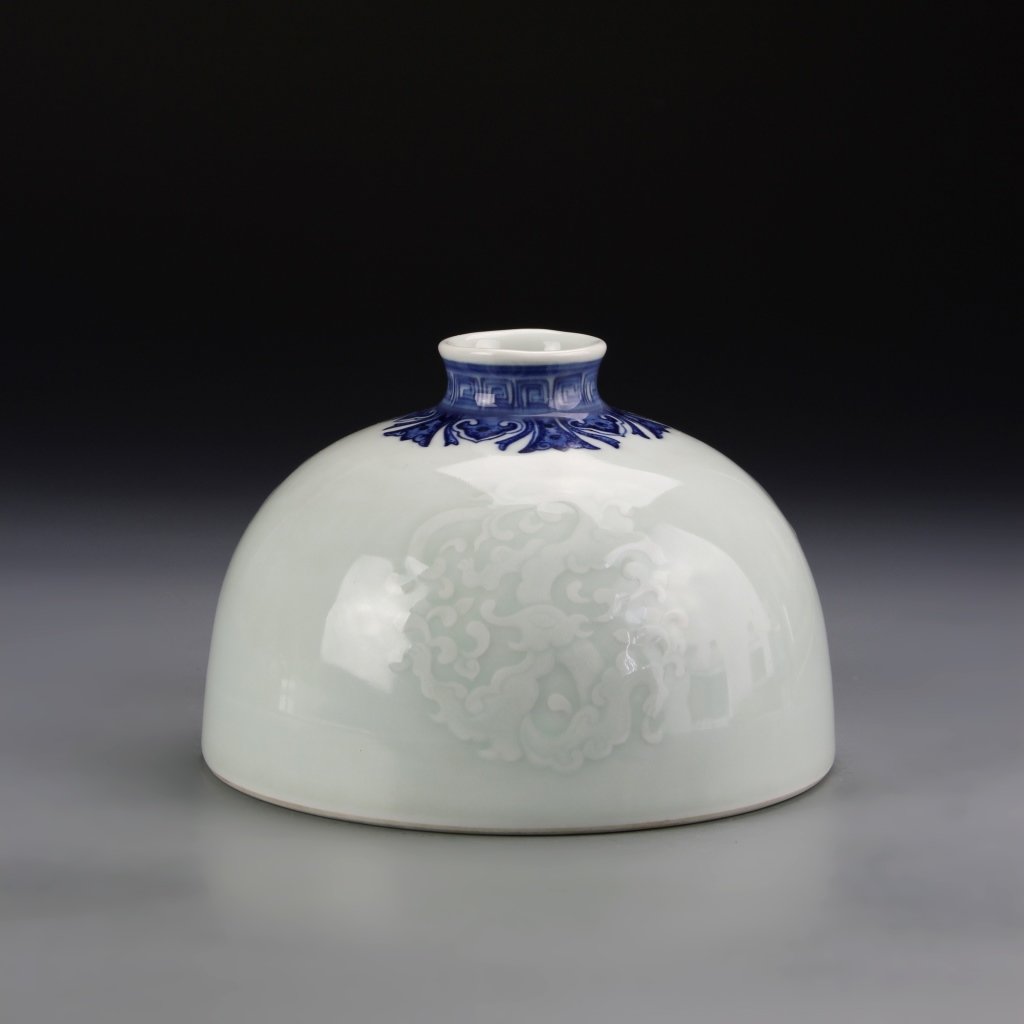 Chinese Celadon Water Coup: China, ROC Period, celadon water coup, with blue and white painting of key fret design around the rim, and raised dragon motifs on the body, Qianlong mark. Height 6 5/8 in., Width 4 1/4 in.