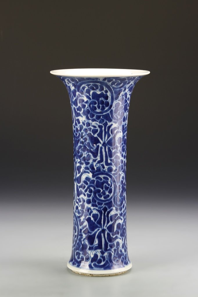 Chinese Blue and White Gu Vase: China, 19th C., blue and white Gu vase, with straight body, tapering to the flared rim, and stylized floral motifs, double ring mark. Height 10 1/2 in.