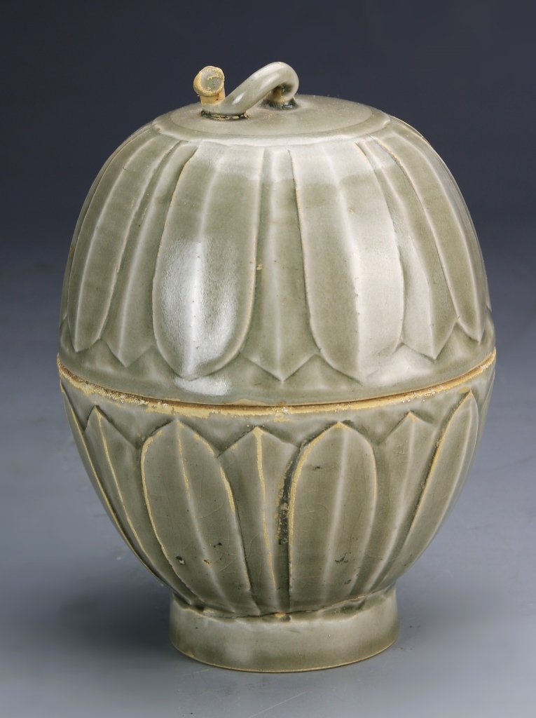 Chinese Celadon Covered Wine Pot: China, celadon wine pot with cover, egg shaped on footed base, with petal design, cover removes to reveal spout, opening mouth and handle. Height 6 in.