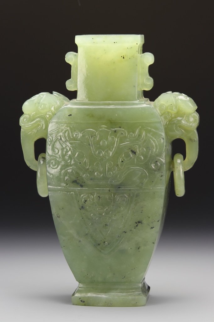 Chinese Carved Jade Vase: China, carved jade vase with square rim and neck, hoop ringed ears shaped as animal heads, on footed base. Height 9 1/2 in., Width 6 1/4 in. Provenance: From the private collection of Mrs. Pearl K. Je