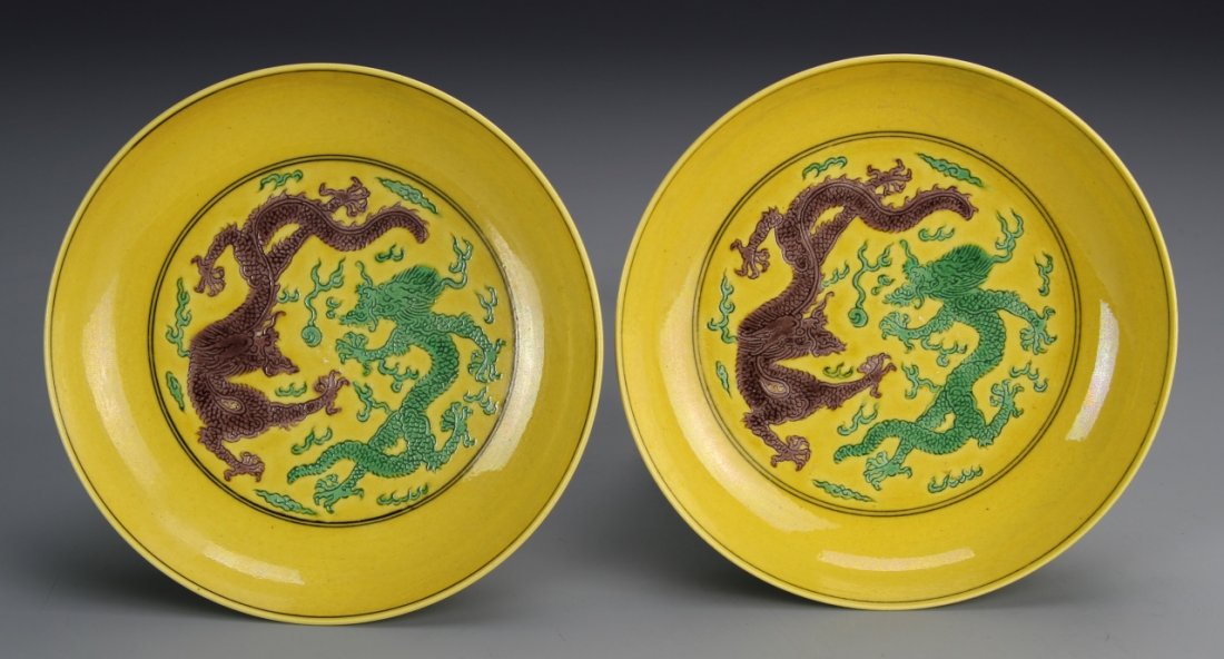 Pair of Chinese Yellow Dragon Dishes: China, a pair of yellow dragon dishes, painted with a green and red dragon in the center, fruit bunches on the outside, with mark in a double circle on the base. Diameter 5 1/4 in.