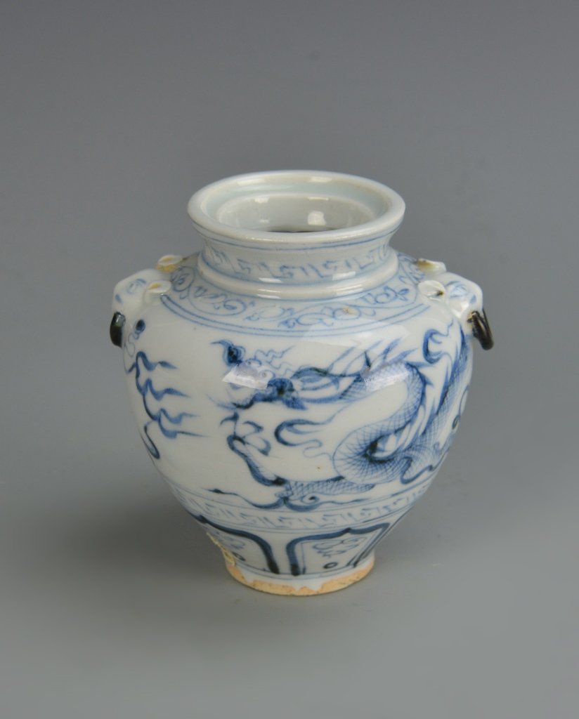 Chinese Antique Blue and White Jar: China, antique blue and white jar, with high shoulder tapering to the base, two attached handles, and delicate floral motifs. Height 4 in.