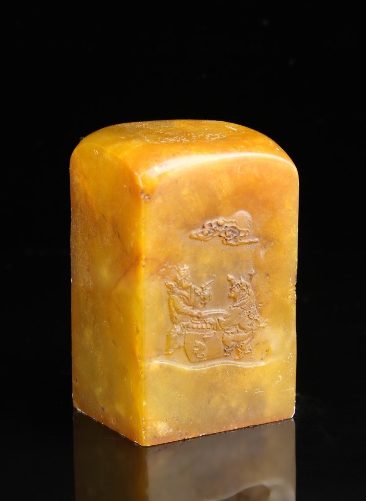 Chinese Soapstone Seal Chop: China, soapstone seal chop, in rectangular form, with rounded top, carved motifs, and in a bright orange hue. Height 2 3/4 in., Width 1 5/8 in., Length 1 3/8 in.