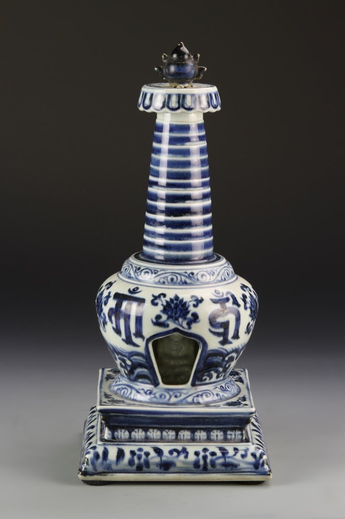 Chinese Blue and White Buddhist Stupa: China, blue and white Buddhist stupa, globular body enshrined with a seated white glazed Buddha, rising to a set of thirteen graduated tiers surmounted by Buddhist vase emblem at the top, and supporte