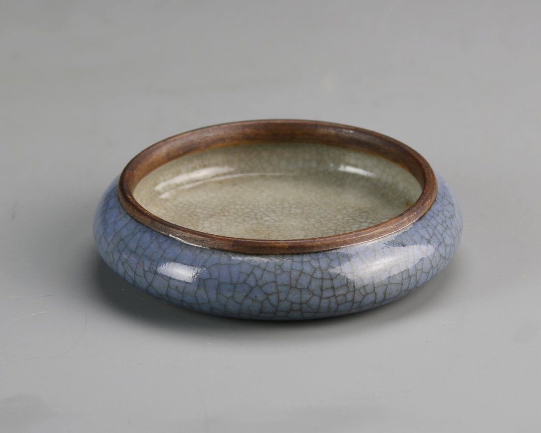 Chinese Ge Yao Ware Brush Washer: China, 19th C., Ge Yao ware brush washer, in circular form, with tapered rim, in a blue hue, with crackle glaze, Guangxu mark. Width 2 3/8 in., Height 1/2 in.