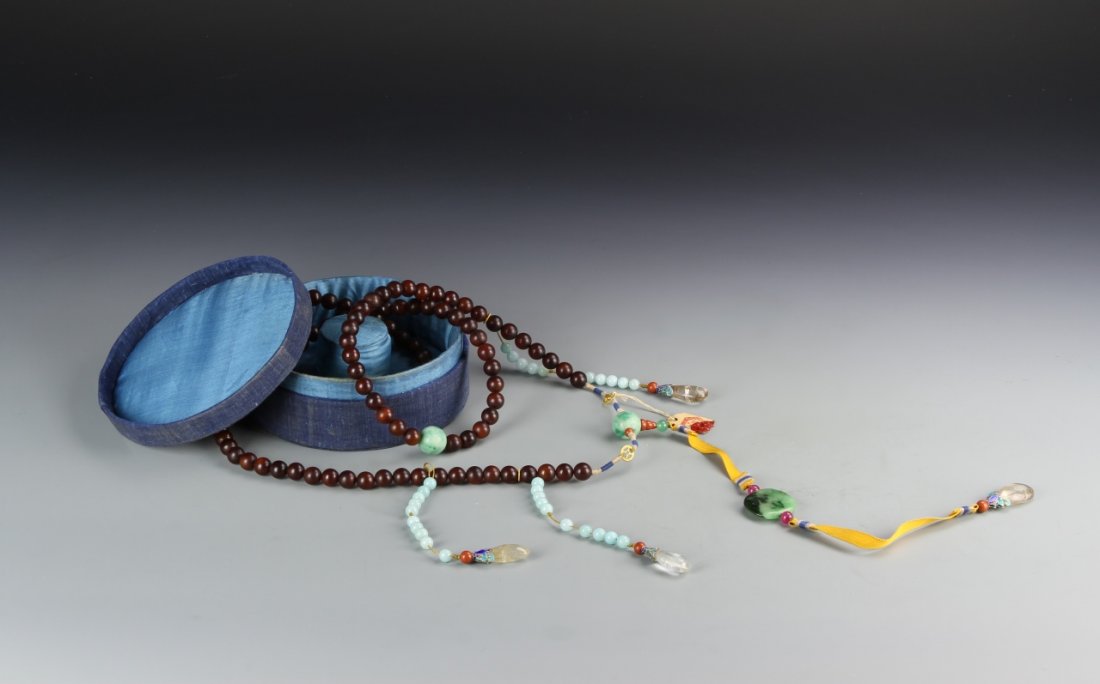 Chinese Imperial Horn Court Necklace: China, Imperial horn court necklace, comprising 108 carved spherical horn beads divided by four larger jadeite beads and attached with three strands of blue carnelian beads, and a carved jadeite beiyu