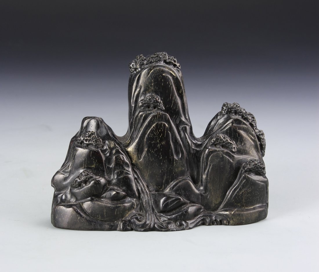 Chinese Zitan Brush Rest: China, zitan brush rest, carved into a dramatic mountain landscape with calligraphy marking and stamp on the back. Height 5 1/4 in.