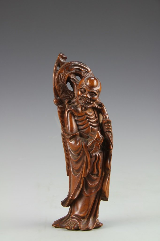 Chinese Boxwood Buddha: China, antique boxwood Buddha, in standing positions, carrying intricately carved objects on back, with distinctively carved ribs. Height 8 in.