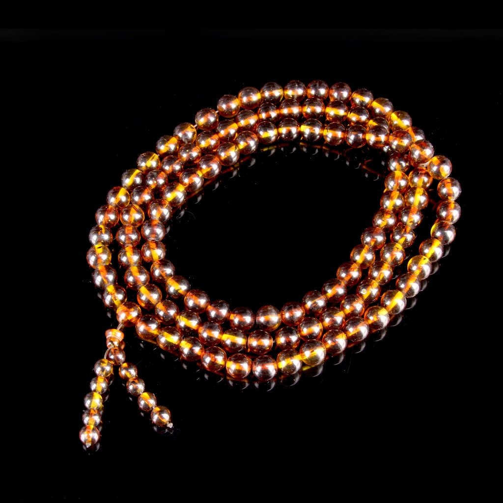 Chinese Vintage Amber Necklace: China, vintage amber necklace, smooth carved, high polished, translucent hued, rounded beads, with a tassel of smaller beads. Length 40 in.