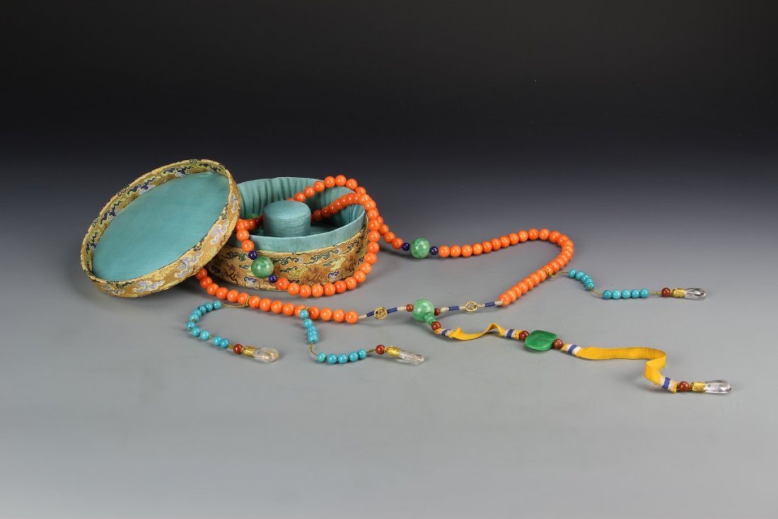 Chinese Coral Court necklace: China, coral court necklace, consisting 108 pink coral beads, divided by four larger jadeite beads, further attached with three strands of turquoise beads, and a center jadeite pendant each suspending