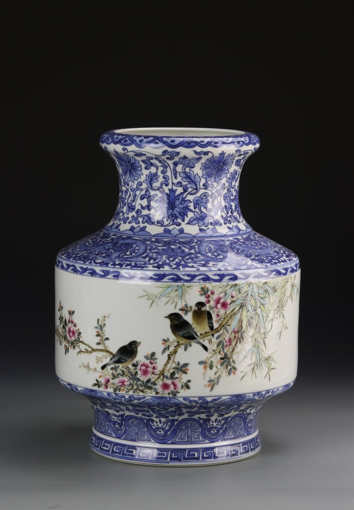 Chinese Blue and White Famille Rose Vase: China, blue and white Famille Rose vase, dense blue decoration around the neck, shoulders and high footed base, painted body depicting birds in colorful trees. Height 11 1/2 in.