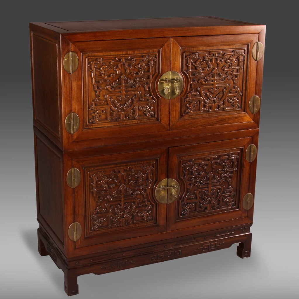 Chinese Huanghuali Cabinet: China, late 19th–early 20th C., Huanghuali cabinet, composed of three sections, each door panel carved in relief of chi dragon and auspicious motifs, brass hinges, and locks. Height 47 7/8 in., Widt