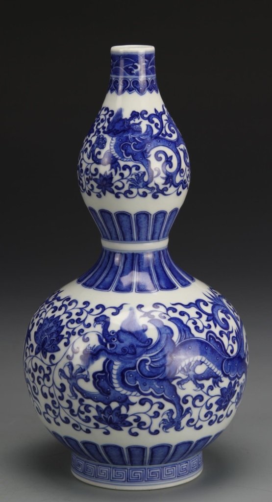 Chinese Blue and White Gourd Vase: China, blue and white gourd vase, painted with dragons and flowers and banded patterning, key fret design around base, Qianlong mark on base. Height 8 1/2 in.