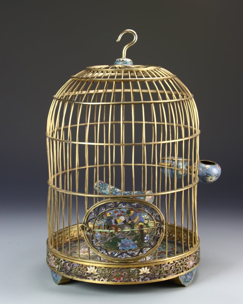 Chinese Cloisonne Bird Cage: China, 19th C., Cloisonne bird cage, with a gilt hued exterior and brightly painted Cloisonne pattern encircling the tripodal footed base, featuring a bird resting upon a perch, mark on base. Height 1