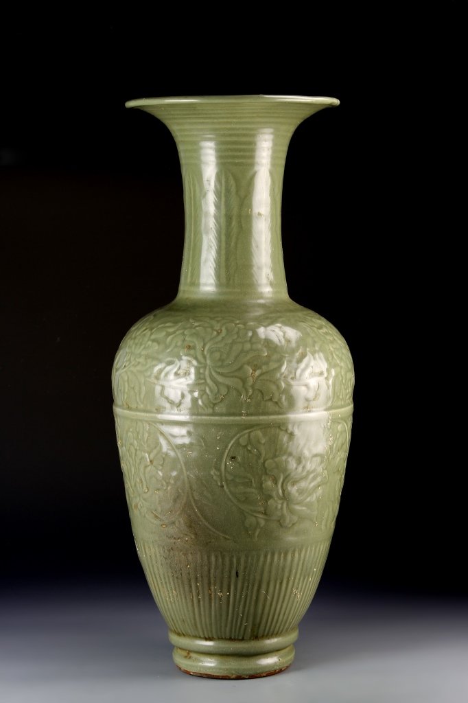 Chinese Antique Gu Vase: China, antique Lungquan ware Gu vase, narrow long neck, with wide flared rim, and slightly raised base, carved foliage design on surface in an apple green glaze. Height 21 in.