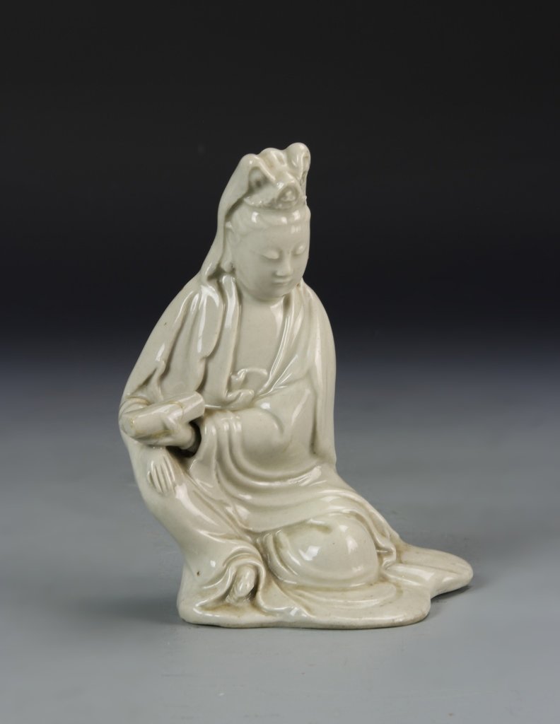 Chinese Glazed Guanyin: China, Ming period, Qing dynasty, glazed Guanyin, painted in a white coloring, in a seated position, with flowing robes and expertly carved facial expression . Height 5 1/2 in.