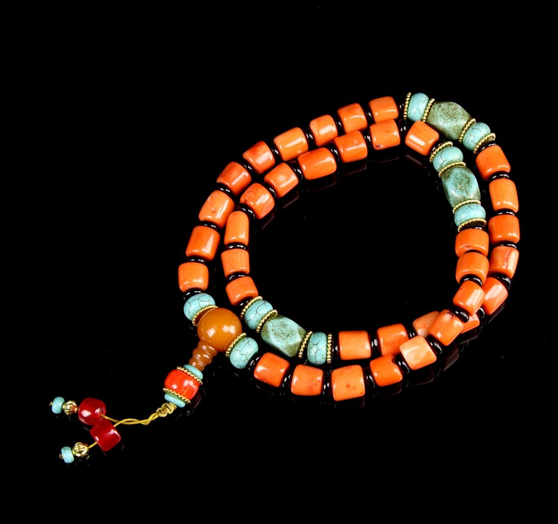 Chinese Tibetan Coral and Turquoise Necklace: China, Tibet, coral and turquoise beaded necklace, each bead divided by a small brown disc bead, with one tasseled extension including two bright pink beads. Length 24 in.