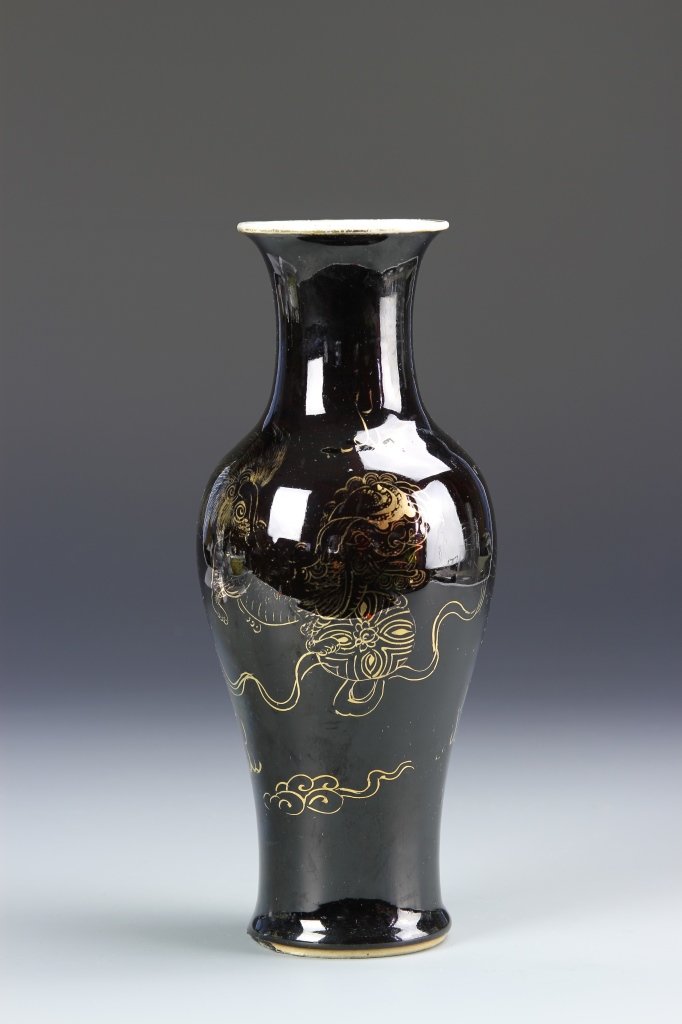 Chinese Famille Noir Vase with Gilt Foo Lion: China, 19th C., Famille Noir vase, flared rim, long neck, wide shoulders with gilt foo lion decoration against black ground, Kangxi mark on base within double circle. Height 10 in.