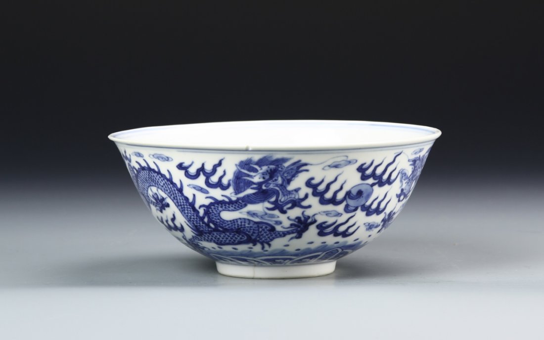 Chinese Blue and White Bowls: China, blue and white bowls, flared rim with tapering sides to footed base, plain interior, with blue dragon design around the exterior, mark on base, minor chips. Diameter 6 1/2 in., Height 2 3/4 in.