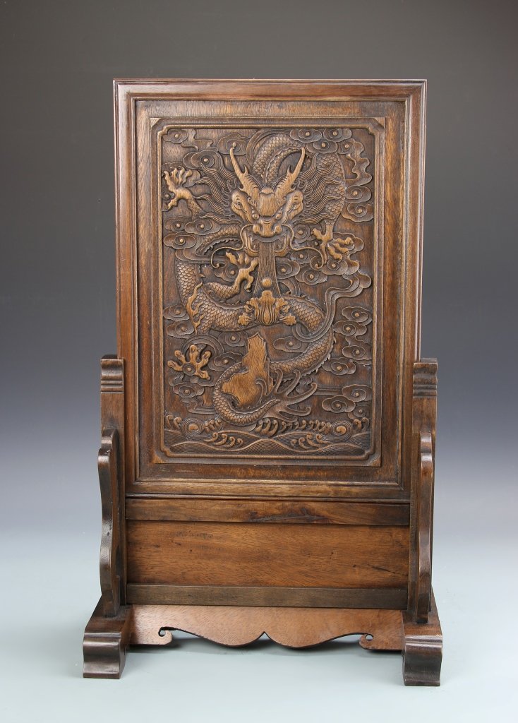 Chinese Hardwood Table Screen: China, 19th C., hardwood table screen, natural wood grain showing, center image carved, showing a scene with a five claw dragon. Height 21 7/8 in., Width 12 3/4 in.