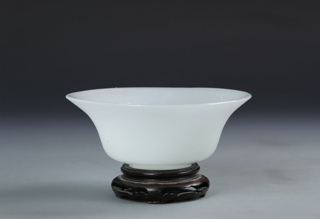 Chinese Peking Glass Bowl with Base: China, 19th C., Qing Dynasty, Peking glass bowl with raised base, flared rim, covered in a opaque white hue with high shine surface. Width 5 3/4 in., Height 2 1/4 in.