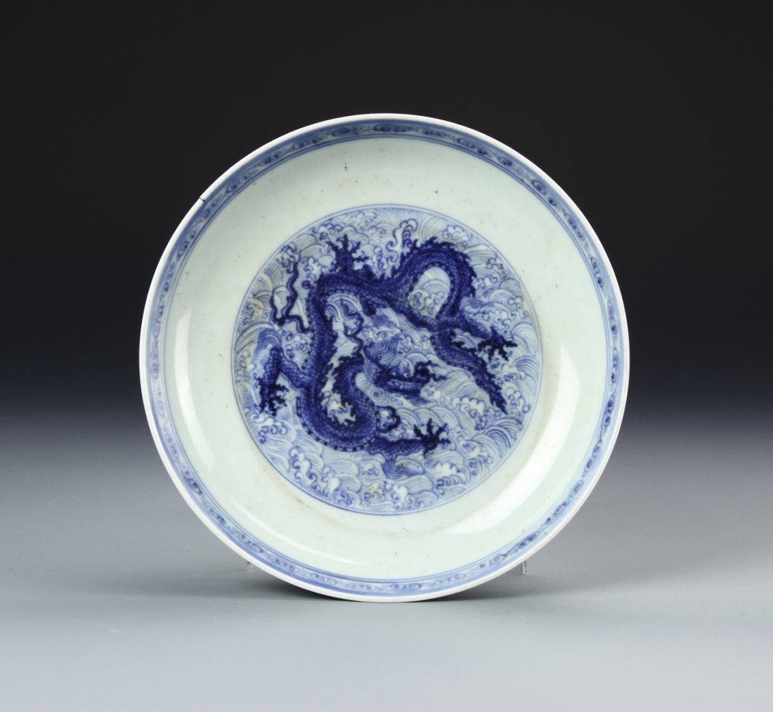 Chinese Blue and White Dragon Plate: China, blue and white dragon plate, floral motifs decorate the exterior, with a dense interior depicting a dragon amongst clouds, Xue de mark on base. Diameter 8 3/4 in.