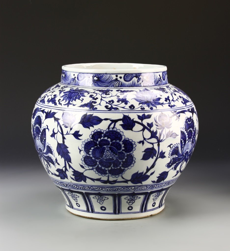 Chinese Blue and White Jar: China, antique, blue and white jar, round wide body, tapering sides to flat base, blue floral designs and scroll borders, unglazed base. Diameter 12 in., Height 12 1/2 in.