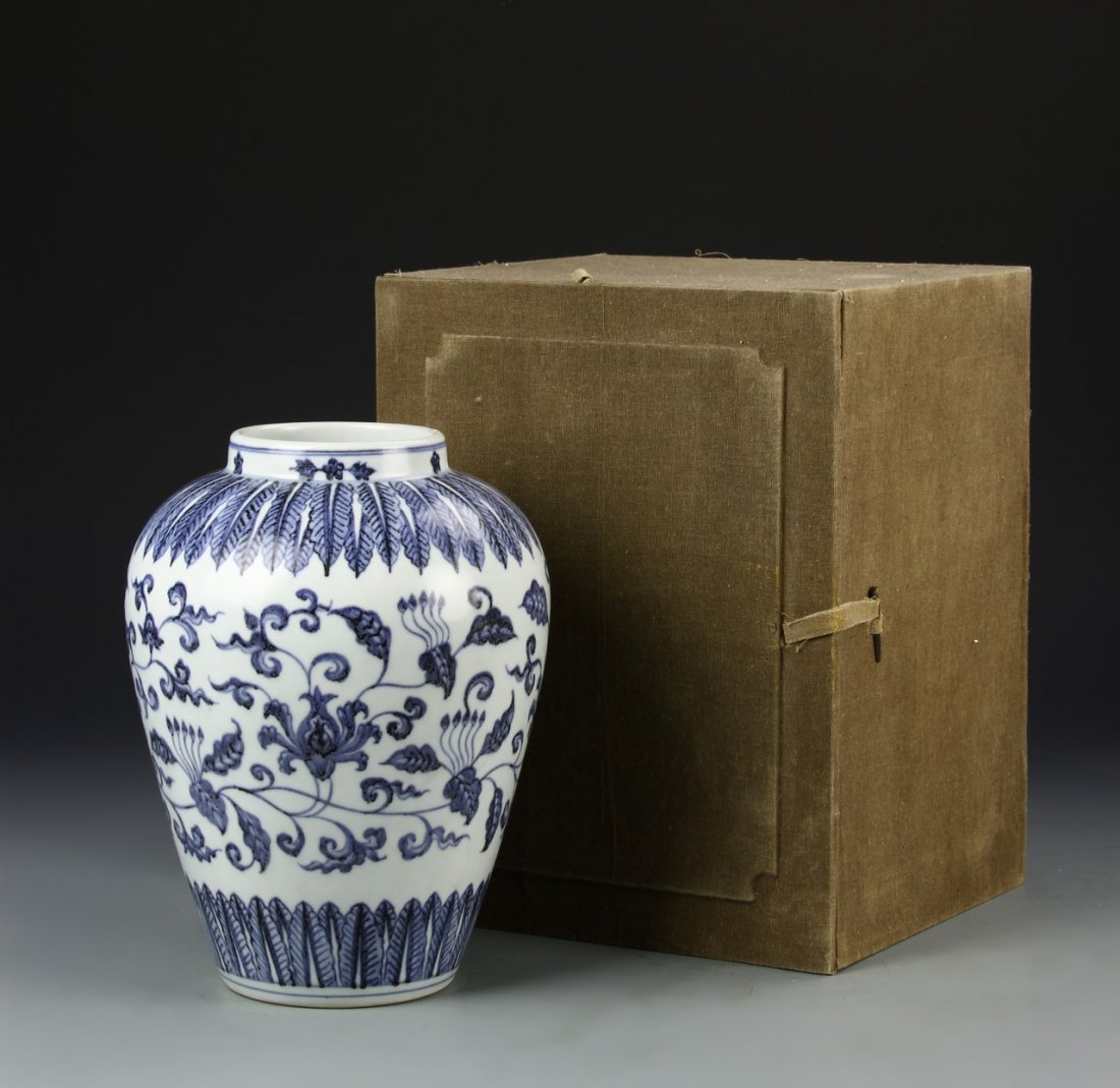Chinese Blue and White Jar: China, Ming dynasty, blue and white jar, wide shoulders, sweeping sides to flat base, painted in blue with feather borders and floral design, complete with box, mark on base. Height 9 1/2 in.