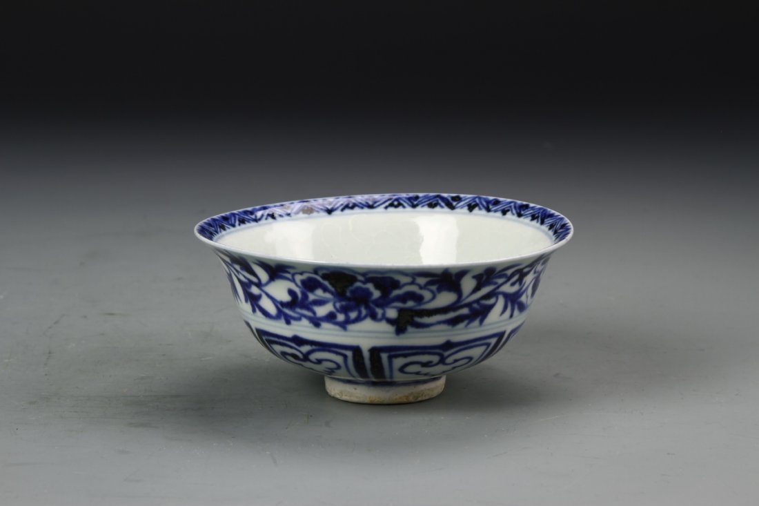 Chinese Blue and White Bowl: China, antique blue and white bowl, resting on a circular foot and with a flared rim, the bowl features a geometric pattern with a floral band around top. Diameter 4 3/4 in., Height 2 1/4 in.