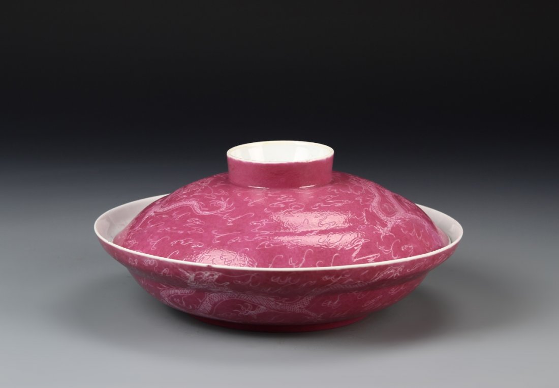 Chinese Pink Glazed Bowl: China, ROC period, expertly crafted pink glazed bowl and lid with incised dragon and cloud motifs, chips and hairline, Qianlong mark. Diameter 10 in.