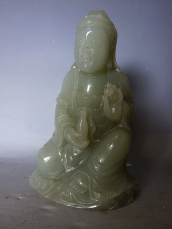 Chinese Figure of Guan Yin: China, carved figure of Yu Bao Ping Guan Yin, sitting barefoot wearing long robes holding a small, medicine urn in one hand and fruit in the other hand. Length 3 in., Width 4 3/4 in.