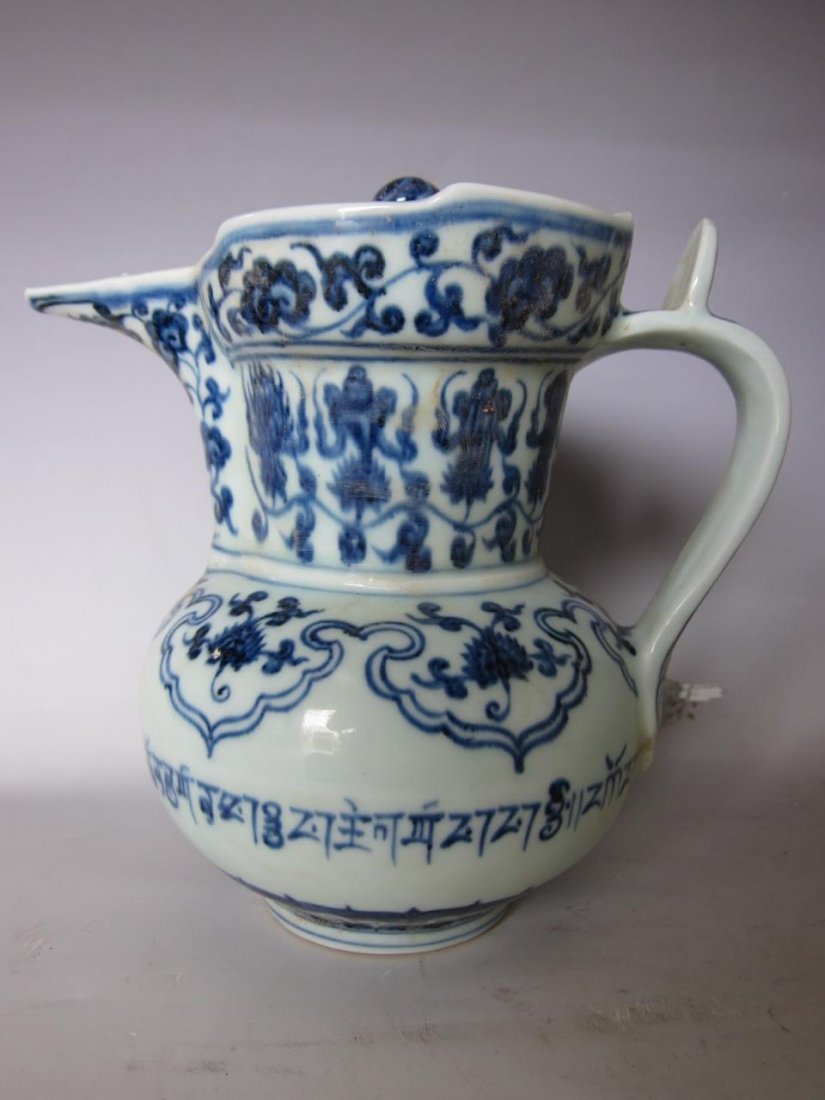 Chinese Blue and White Ewer: China, antique blue and white ewer, with lid and handle, blue floral and geometric patterns throughout against white ground. Length 7 1/4 in., Height 7 1/2 in.