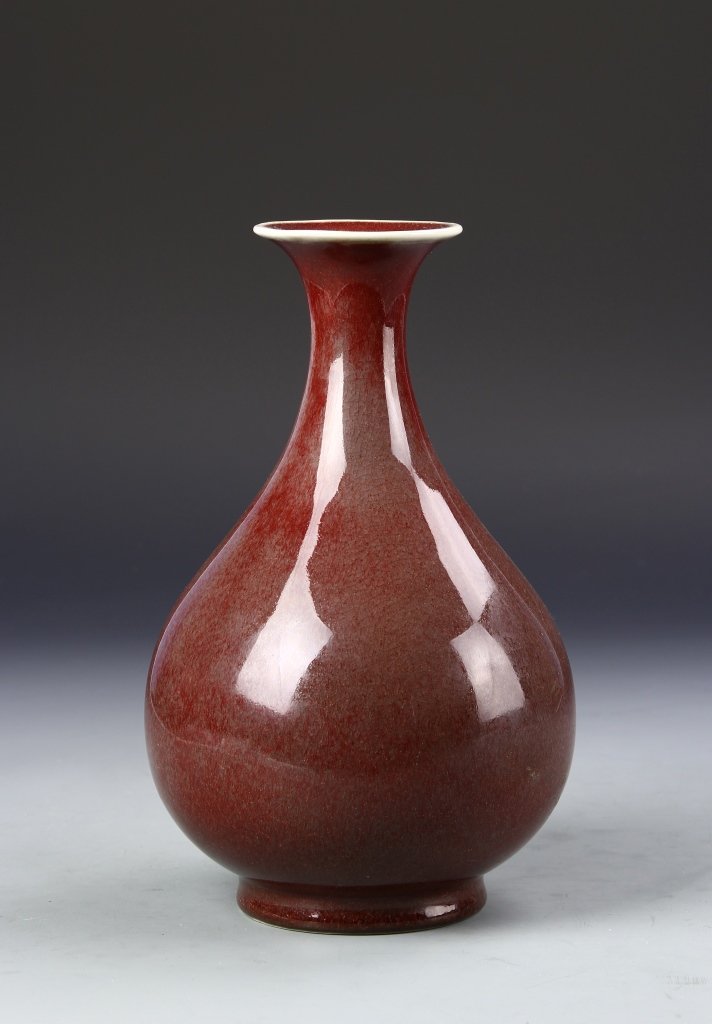 Chinese Oxblood Yuhuchunping Vase: China, 19th C., oxblood Yuhuchunping vase, flared, wide rim at mouth, skinny neck and bulbous body in mottled red glaze with speckling throughout. Height 10 1/4 in.