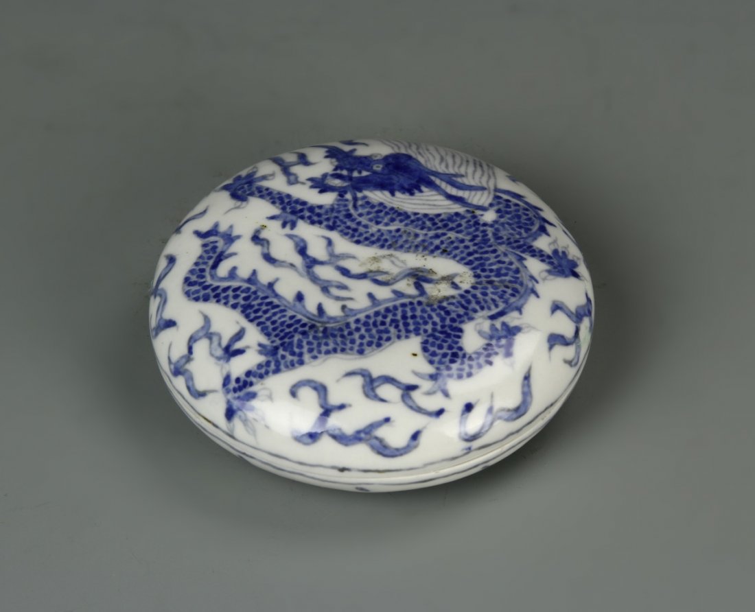 Chinese Blue and White Ink Box: China, blue and white Ink Box, round body with fitted cover, blue image of a twisting dragon against white ground, Qianlong mark on base. Length 3 in., Height 3 1/4 in.