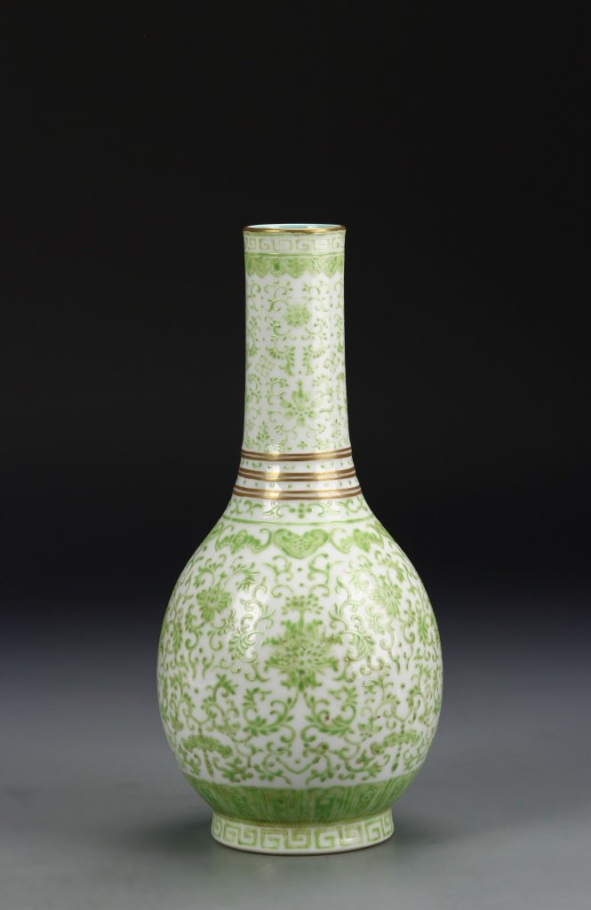 Chinese Famille Rose Vase: China, 19th century, green Famille Rose vase, on a raised base, in an oval form, with a long, narrow neck and flat rim, delicately glazed with a pale green pattern over a white ground, with Dao Guang 