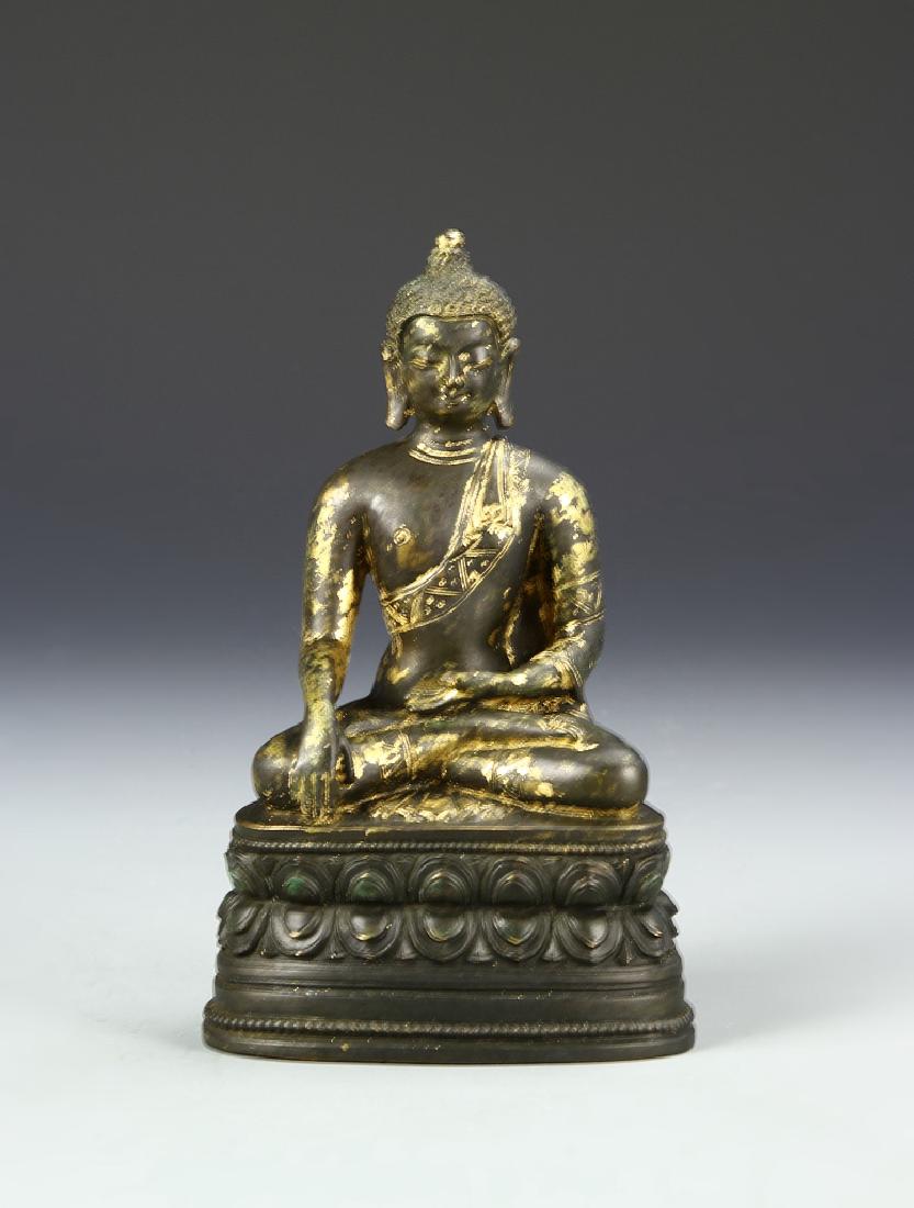 Chinese Bronze Buddha: China, bronze Buddha, seated male figure wearing simple robes with legs crossed and arms placed in Madras pose on a darker shade, double lotus base with mark on the underside of base. Height 6 3/4 in.