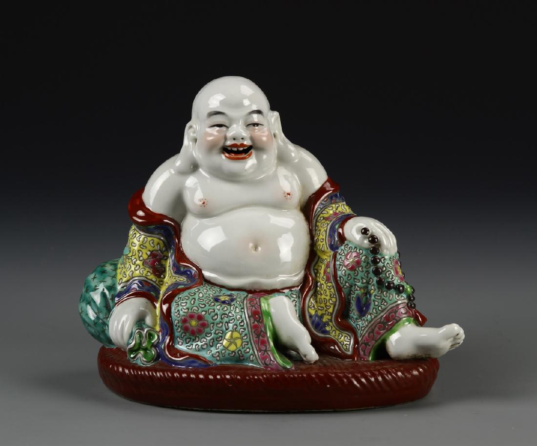 Chinese Famille Rose Buddha Statue: China, Famille Rose Buddha, seated, happy figure with large belly and bald head, wearing colorful robes decorated with symbols, mark on flat base. Height 6 in.