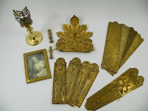 A mixed lot of old brass; A Victorian Gothic eccle: A mixed lot of old brass; A Victorian Gothic ecclesiastical candle stick with twisted, knopped stem, broad castellated sconce, and stepped round base 20cms, a desk seal with Fleur de Lys finial, a des