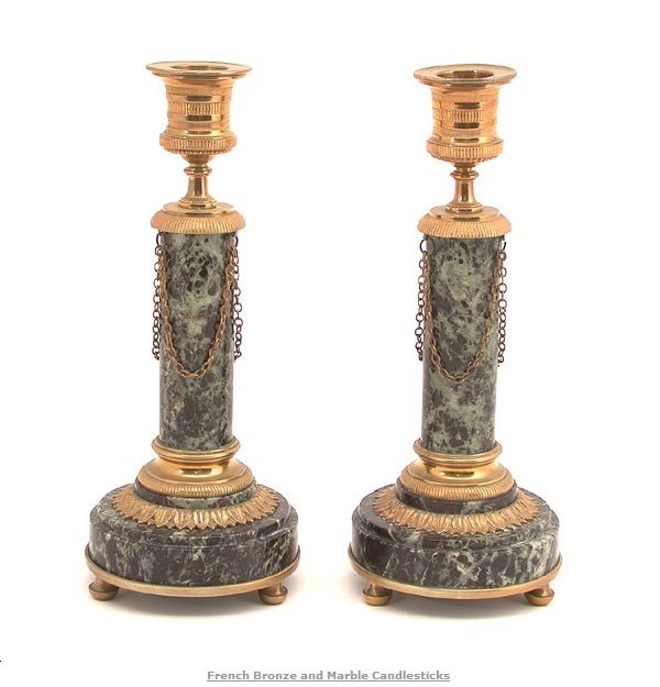 PAIR OF FRENCH BRONZE AND MARBLE CANDLESTICKS.: Pair of French bronze and marble candlesticks on raised ball feet with chain decoration. 9" h, in very good condition.